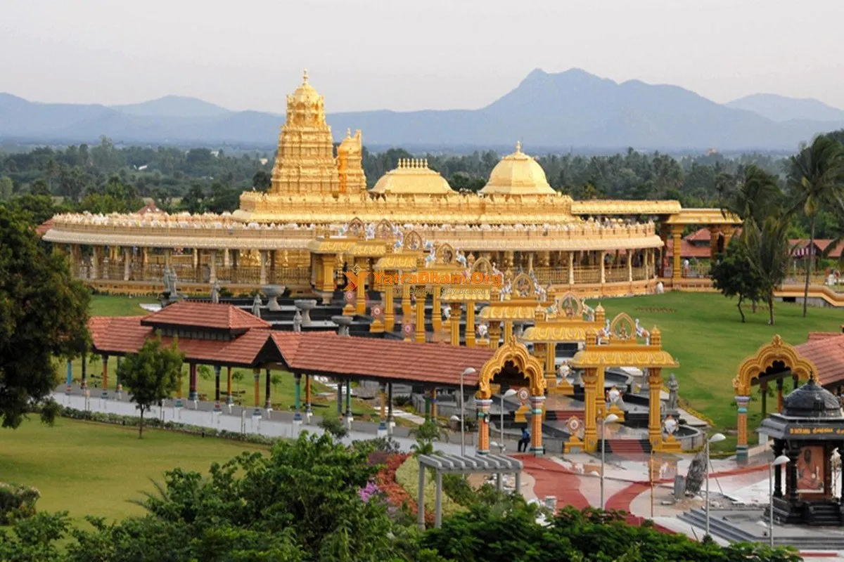 The Sri Lakshmi Narayani golden temple at Sripuram seen across its lawns and landscaped grounds, with low hills on the horizon